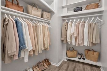 Closet with clothes and shoes.