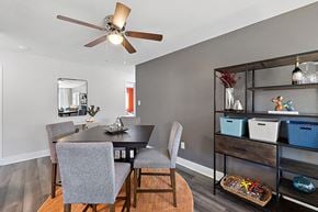 Riverview apartment for rent - a dining room with a table and chairs and a ceiling fan