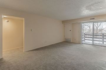 Lansing apartment for rent - an empty living room with a sliding glass door