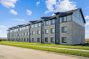 Mount Vernon apartment for rent - A large grey building with a lot of windows and doors.