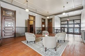Clinton apartment for rent - A living room with a grey sofa, a grey armchair, a wooden floor and a rug.