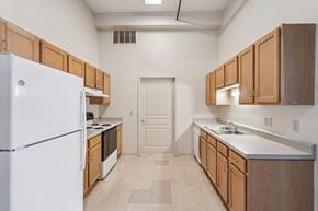 Clinton apartment for rent - A kitchen with wooden cabinets and a white refrigerator.