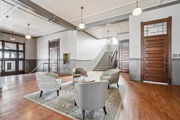 Clinton apartment for rent - A living room with a grey sofa and a wooden door.