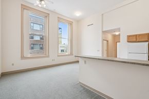 Clinton apartment for rent - A spacious room with a large window and a ceiling fan.