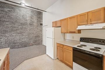 Clinton apartment for rent - A kitchen with a white refrigerator and a white stove top oven.