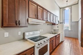 Clinton apartment for rent - A kitchen with wooden cabinets and a white stove top oven.