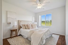 Mount Vernon apartment for rent - A bedroom with a large bed and a ceiling fan.
