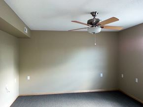Columbus Junction apartment for rent - an empty room with a ceiling fan