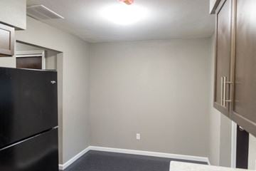 Fairfield townhouse for rent - A black refrigerator sits in a kitchen next to a wall.
