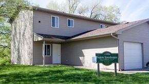 Ottumwa apartment for rent - A house with a sign that says Prairie Townhomes in front of it.