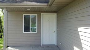 Ottumwa apartment for rent - A small house with a white door and window.