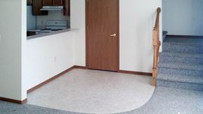 Ottumwa apartment for rent - A brown door is in a white hallway.