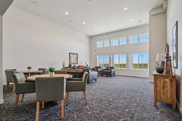 Mount Vernon apartment for rent - A spacious living room with grey chairs and a carpeted floor.
