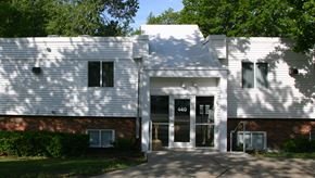 Ames townhouse for rent - A white building with a black door and windows.