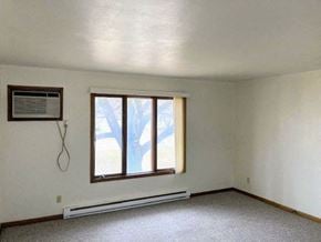 Milford apartment for rent - an empty living room with a window and a heater