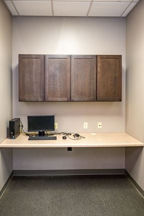 Sioux City apartment for rent - A workspace with a computer, keyboard, mouse, and headphones on a desk.