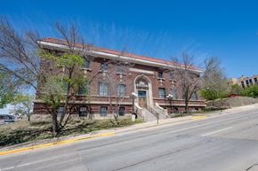 Sioux City apartment for rent - A large red brick building with a staircase leading to the front door.