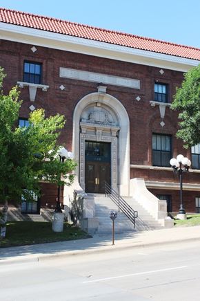 Sioux City apartment for rent - A red brick building with a large arched entrance.
