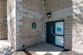 Sioux City apartment for rent - A green door is on the right side of the building.