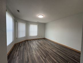 Des Moines apartment for rent - A room with wooden flooring and two windows.