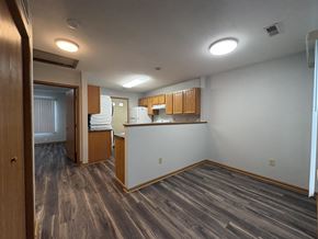 Des Moines apartment for rent - A room with wooden flooring and a kitchenette.