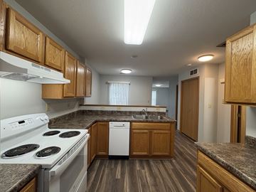 Des Moines apartment for rent - A kitchen with a white stove top oven and a white dishwasher.