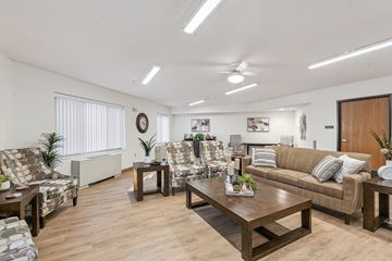 Des Moines apartment for rent - A living room with a brown couch and a wooden coffee table.