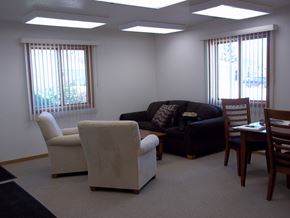 Webster City apartment for rent - A living room with a couch, chairs, and a table.
