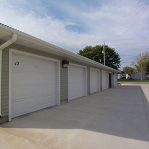 Humboldt apartment for rent - A row of white garage doors are closed and numbered 12.