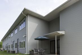 Humboldt apartment for rent - A house with a grey siding and a white roof.