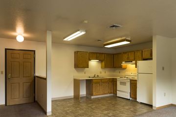 Humboldt apartment for rent - A kitchen with white appliances and wooden cabinets.