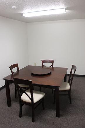 Spirit Lake apartment for rent - A brown wooden table with four chairs around it.