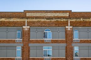 Sioux City apartment for rent - A brick building with the words "Lessonich Building" on the top.