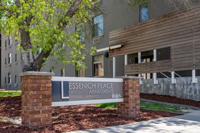 Sioux City apartment for rent - A sign for Essenich Place Apartments stands in front of a building.