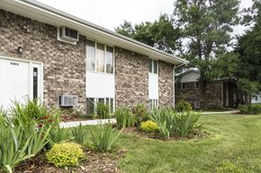 Milford apartment for rent - A brick house with a white door and windows.