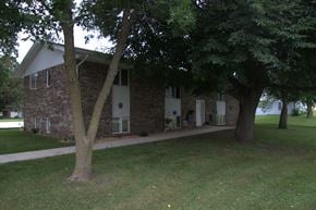 Milford apartment for rent - A small building with a white roof and a tree in front of it.