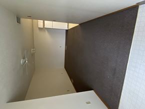 Sioux Center apartment for rent - A white laptop is on a white desk in a room with a brown wall.