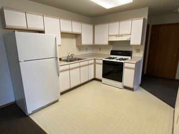 Sioux Center apartment for rent - A kitchen with white appliances and white cabinets.