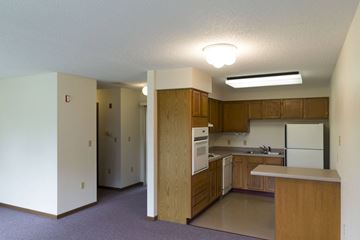 Sibley apartment for rent - A kitchen with wooden cabinets and a white refrigerator.