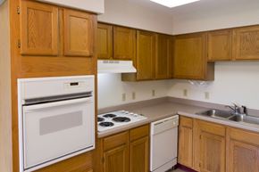Sibley apartment for rent - A kitchen with wooden cabinets and a white oven.