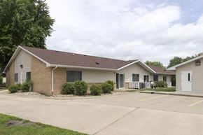 Sibley apartment for rent - A small building with a brown roof and a white door.