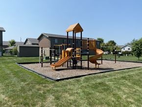 Sheldon apartment for rent - A playground with a yellow slide and a brown structure.