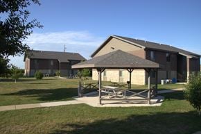Sheldon apartment for rent - A large building with a covered patio in front.
