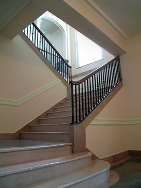 Mason City apartment for rent - A staircase with a black railing and beige steps.