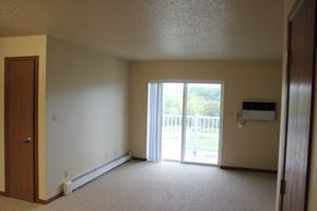 Milford apartment for rent - A room with a sliding glass door leading to a balcony.