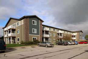 Milford apartment for rent - Apartment building with cars parked in front.