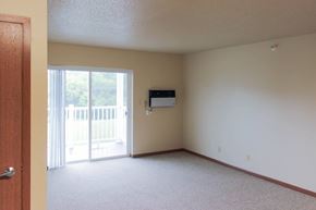 Milford apartment for rent - A room with a sliding glass door leading to a balcony.