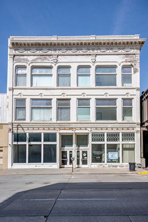 Sioux City apartment for rent - A white building with a blue sign on the front.