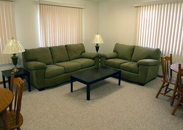 Council Bluffs apartment for rent - A living room with a green couch and a coffee table.