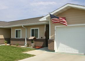 Council Bluffs apartment for rent - A house with a flag on the roof.